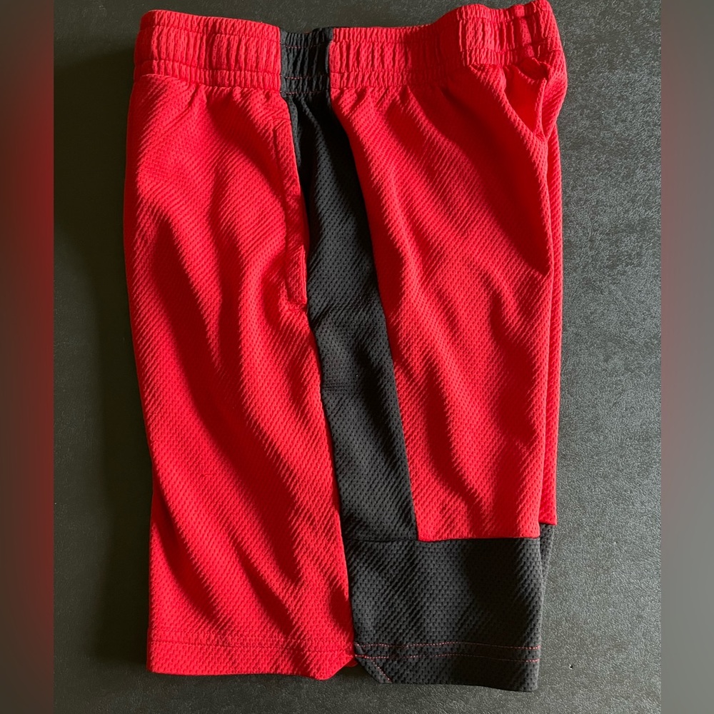 Boys shorts are red with black stripe size 10/12 Tek Gear